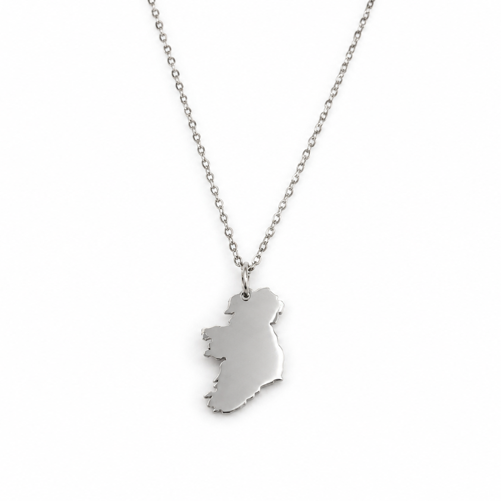 A silver necklace featuring a pendant shaped like the map of Ireland, shown against a plain white background.