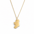 A gold necklace featuring a polished pendant shaped like the map of Ireland, suspended from a delicate gold chain against a plain white background.